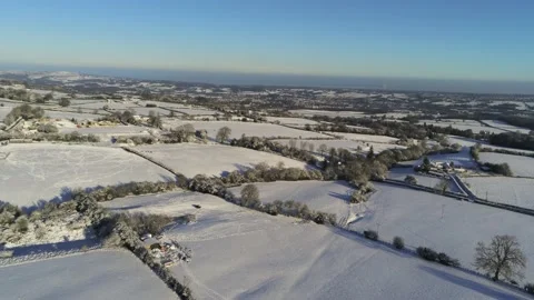 Cold snowy winter British patchwork farmland countryside rural scene Stock Footage 146523349