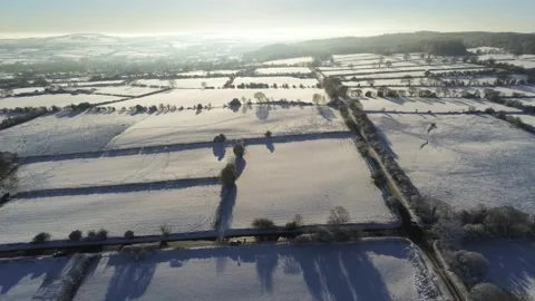Cold snowy winter British patchwork farmland countryside rural scene Video stock 146523392