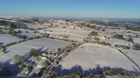 Cold snowy winter British patchwork farmland countryside rural scene Stock Footage 146523676