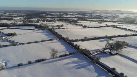 Cold snowy winter British patchwork farmland countryside rural scene Stock Footage 146523712