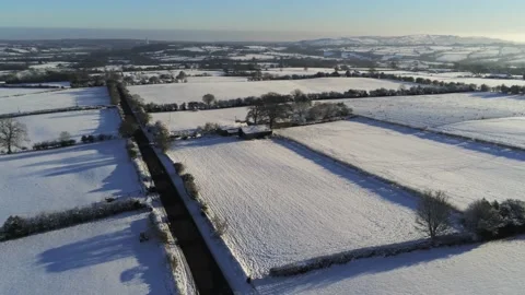 Cold snowy winter British patchwork farmland countryside rural scene Stock Footage 146523823