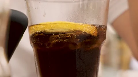 Cold soda cola beverage with lemon slice and ice cubes  Dark soft drink cocktail Stock-Footage 218591204
