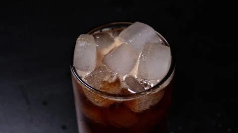 Cold Soft Drink with Ice Cubes in Glass on Dark Background. Stock Footage 328118475