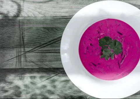 Cold soup of beetroot and vegetables with herbs on wooden background Stock Photos