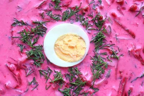Cold soup closeup. Cold beet soup with egg and dill. Stock Photos