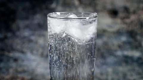 Cold sparkling water with ice on a dark background. Stock Footage 255287625