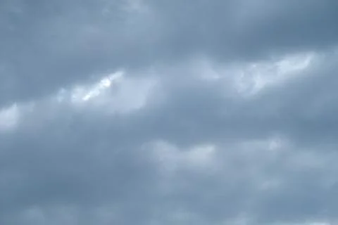 Cold spring clouds on a heavy blue sky Stock Photos