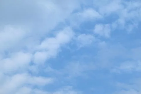 Cold spring clouds on a heavy blue sky Stock Photos