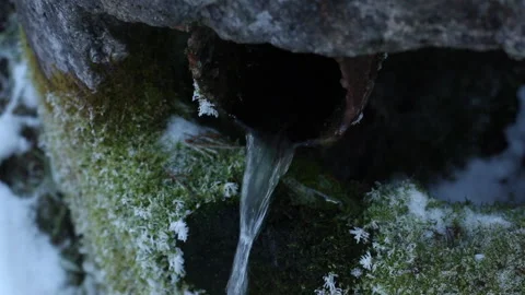 Cold spring water flows from a pipe Video stock 166642874