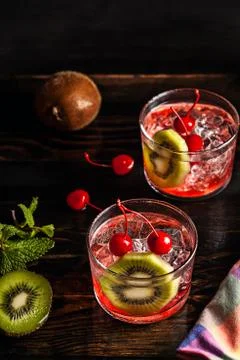 Cold summer cocktail drink with cherry and kiwi Stock-Fotos
