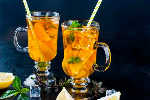 Cold tea with lemon, mint and ice Stock Photos