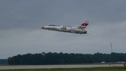 Cold War era F-100 Super Sabre performs a flyby Stock Footage 111839744