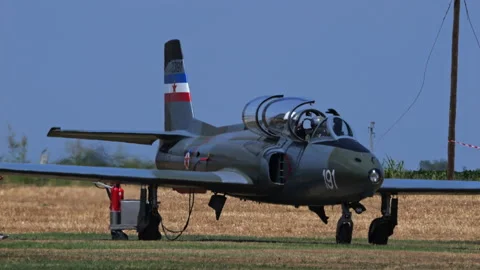 Cold War era military jet airplane waiting for take off with engine running Stock Footage 218950702