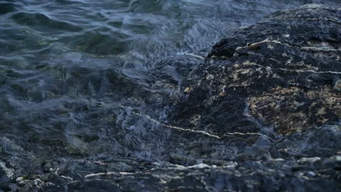 Cold water on black rocks, 4k, slow mo Video stock 243537791
