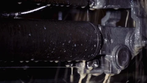 Cold water cools the machine in the workshop. The string moves to cut parts. Stock Footage 116443977