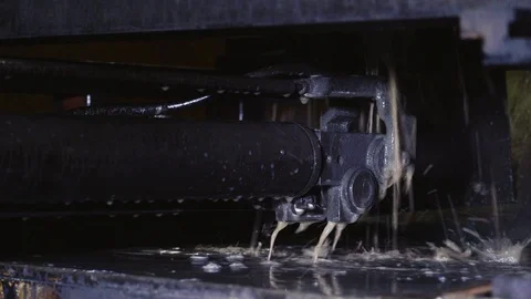 Cold water cools the machine in the workshop. The string moves to cut parts. Stock Footage 116443994