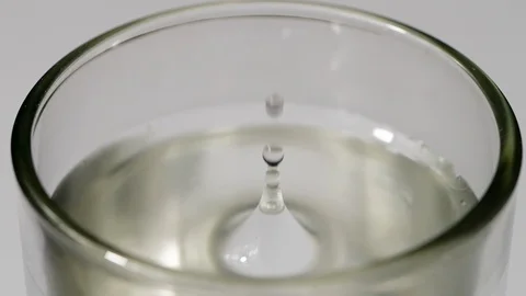 Cold water drop into drinking glass in slow motion Stock Footage 113594172