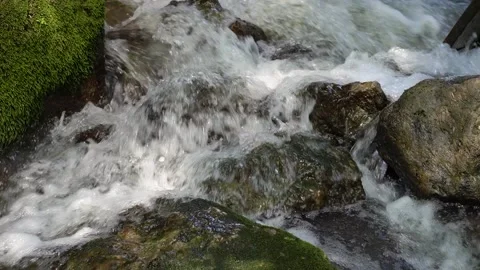 Cold water flowing over rocks Stock Footage 130340930