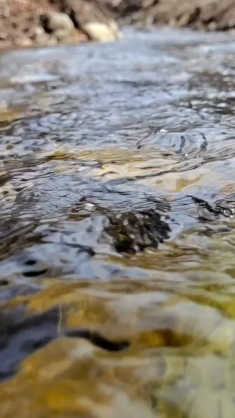 Cold water flowing over rocks Stock-Footage 303990606