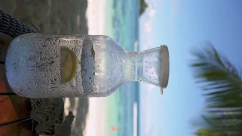 Cold water in a misted jug, filled with ice and lemon Stock Footage 154807461