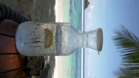 Cold water in a misted jug, filled with ice and lemon Stock Footage 154807546