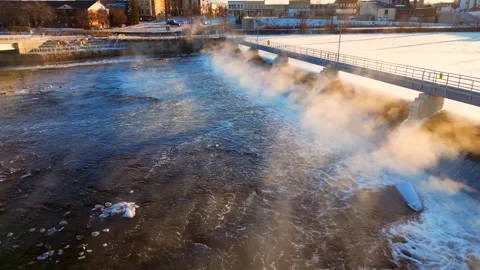 Cold waters steaming in colder air on a sub-zero Winter morning, aerial view Stock Footage 299377853