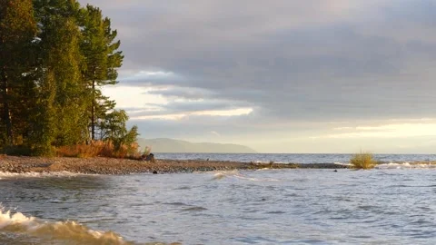 Cold waves of Lake Baikal in cloudy weather at sunset. Stock Footage 285381222