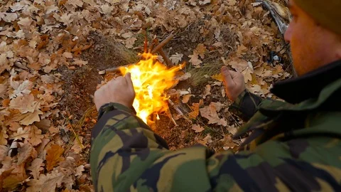 Cold weather and fire at forest. Old hunter has a rest Video stock 100631537