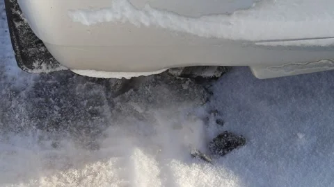 Cold weather causes snow to build up around car exhaust pipe on a winter morning Video stock 326766152