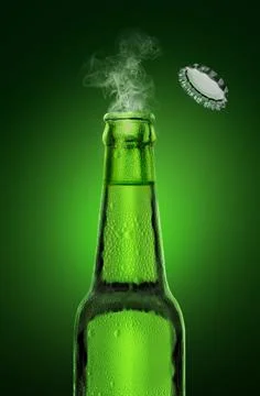 Cold wet open beer bottle with smoke on green background Stock Photos