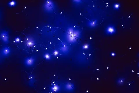 Cold white led string lights navy blue background Stock Photos