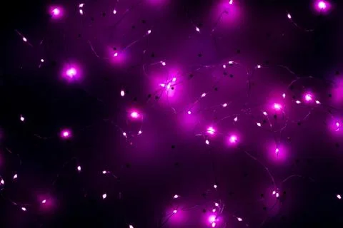 Cold white led string lights purple background Stock Photos