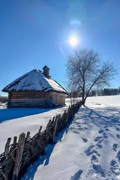 Cold white winter colors light up the countryside among old wooden houses Photos
