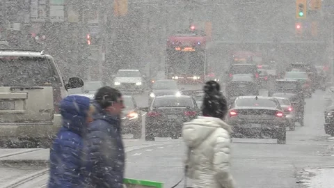 Cold winter and snow with high wind and people waling  plus traffic in Toronto Stock Footage 171783732