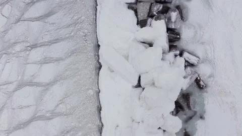 On a cold winter day in the north, there is a lighthouse frozen in ice. Stock Footage 169983533