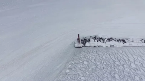 On a cold winter day in the north, there is a lighthouse frozen in ice. Stock-Footage 169983724