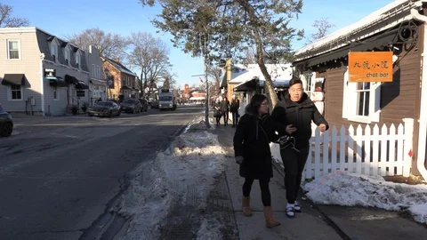 Cold winter day on small town main street with people and Christmas decorations 库存影片 119920889