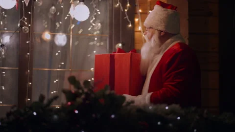 On a cold winter night Santa Claus brings a gift to the children's house and Stock Footage 166160876