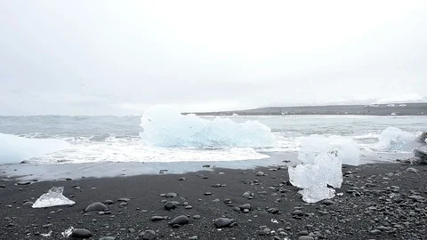 Cold winter one blue glacier iceberg in Jokulsaron lagoon lake Iceland Stock Footage 93787697