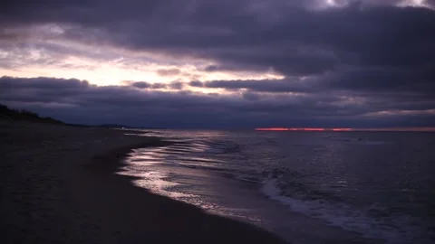 Cold winter windy Baltic sea coast beach in twilight purple light with dramatic Stock Footage 145955960