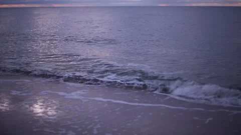 Cold winter windy Baltic sea coast beach in twilight purple light with dramatic Stock Footage 145956012