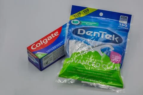 Colgate toothpaste and DenTek floss picks closeup on white background Stock Photos