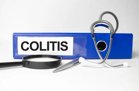 Colitis word on blue file folder and stethoscope on white background Stock Photos