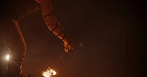 Coll fire show artists having a performance in the dark, swinging fire pieces- Stock Footage 100997495