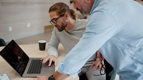 Collaborating on a code: Software designers working as a team in a tech startup Stock Footage 251586866