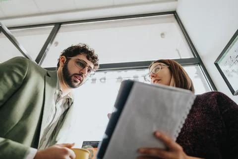 Collaborating colleagues analyzing data for business growth in corporate office. 스톡 사진