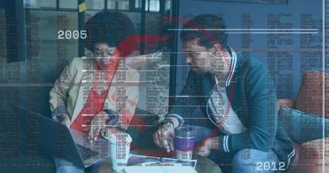 Collaborating colleagues discussing code and charts on laptop at office lounge, Foto stock