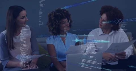 Collaborating colleagues examining printed documents in office lounge with la Stock Photos