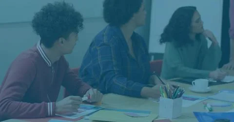 Collaborating colleagues planning workshop in office with paper shapes, pencils Stock Photos