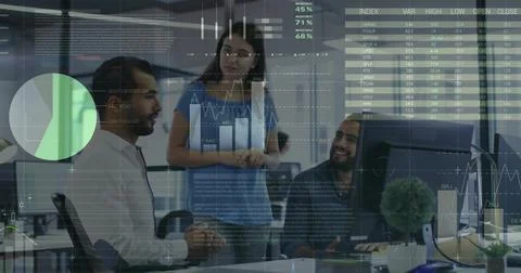 Collaborating colleagues reviewing analytics at computer monitor in office, 库存照片